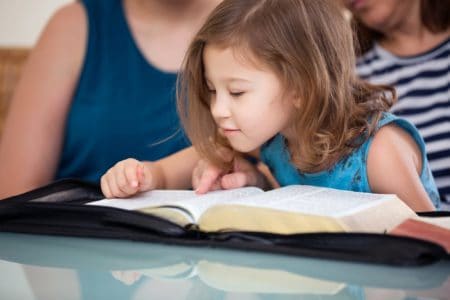 Young girl reading the bible