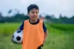 Hispanic boy holding a soccer ball