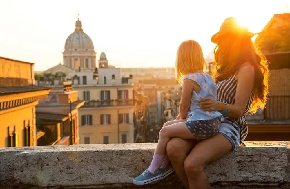 Italian girl and mother overlooking Italian city
