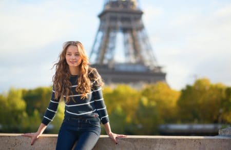 French girl in front of the Eiffel Tower