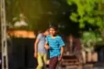 Native american boy playing cricket outdoors
