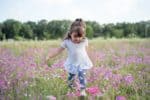 Turkish toddler girl running in the flower field
