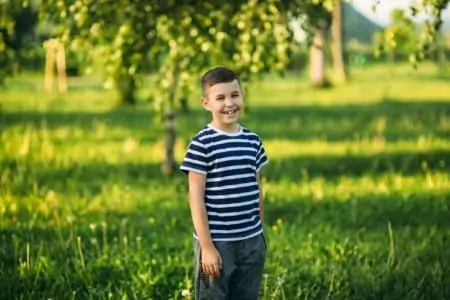 Smiling Dutch boy in a striped shirt at the park