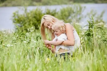 Norwegian boy kid and mother spending time in grass