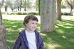 Portuguese young boy smiling at the park