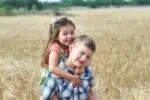 Italian siblings having fun in wheat field
