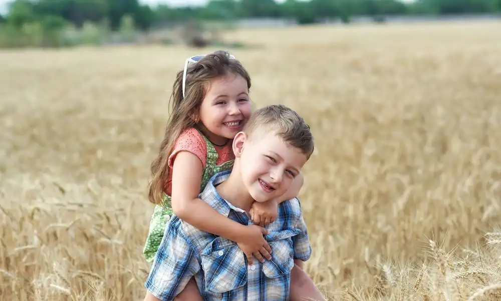 Italian siblings having fun in wheat field