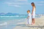 Beautiful girl and boy standing at the beach