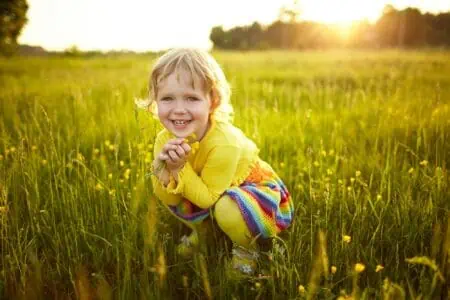 Cute little happy girl on the meadow