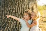 Adorable siblings hugging each other in nature background