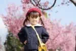 Japanese little girl wearing kindergarten uniform in spring park