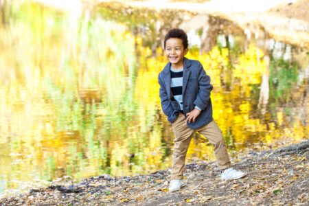 Adorable little boy posing in autumn park