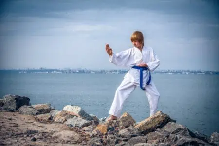 Young boy training karate at seaside