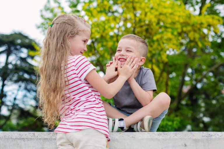American sibling having fun playing in the park