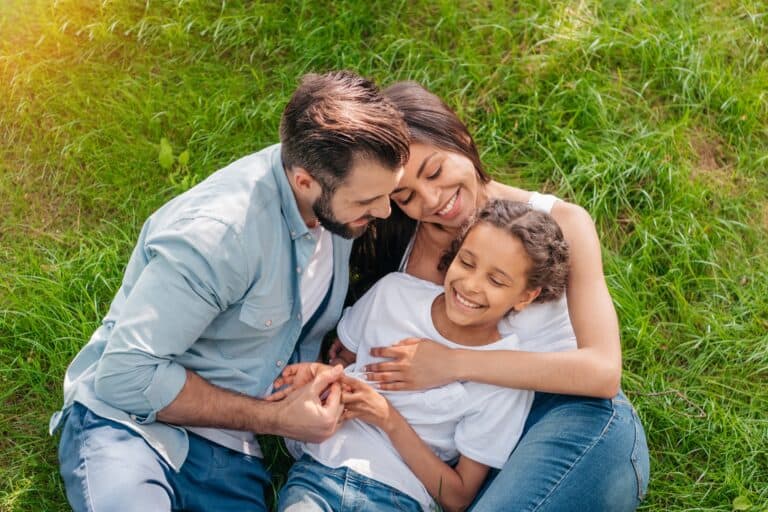 Lovely family sitting on the grass