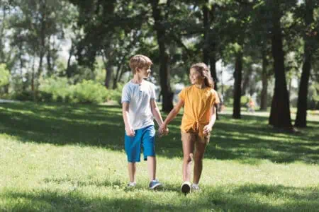Kids walking at the park while holding hands