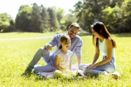 Adorable family having fun in the park on a sunny day